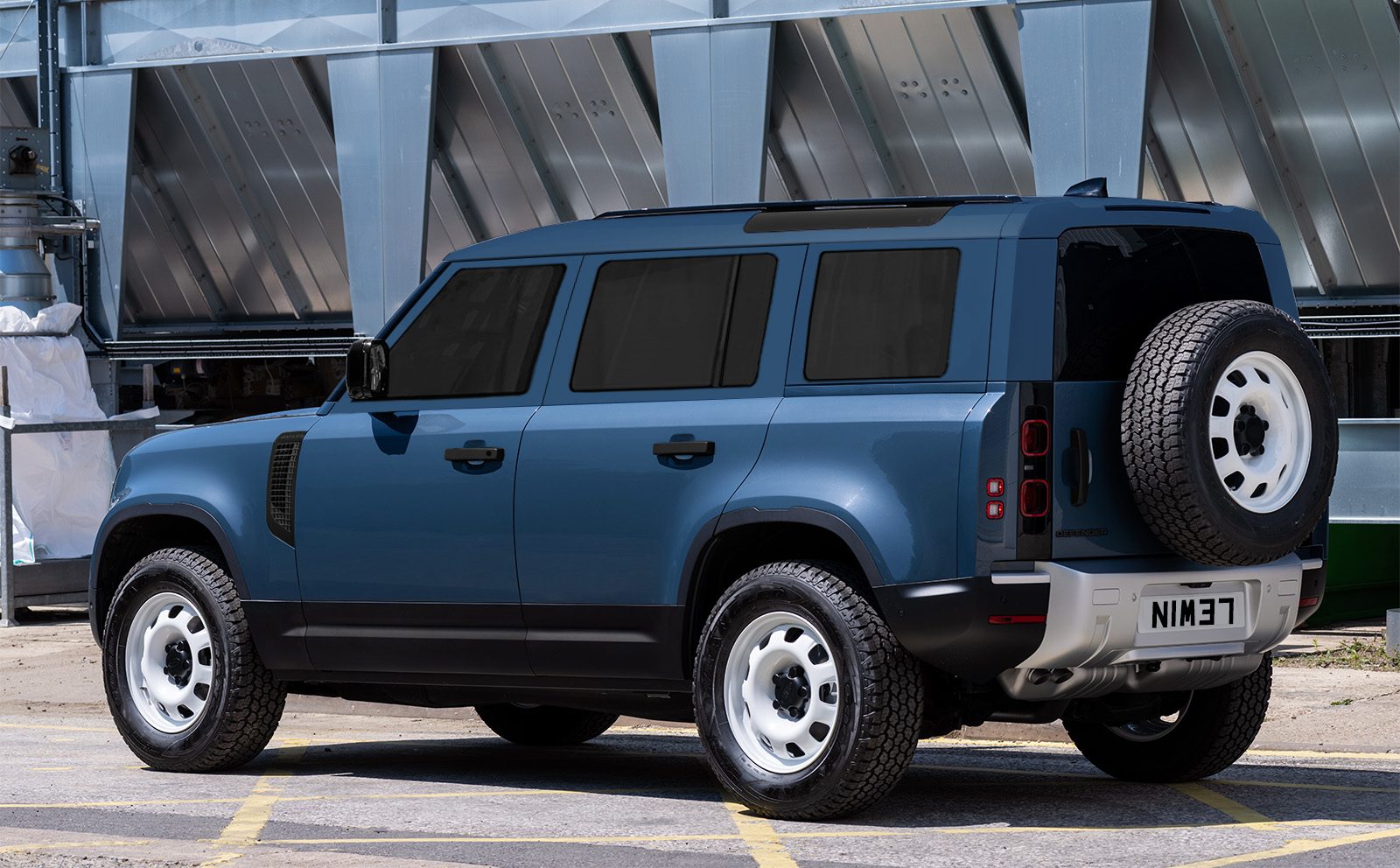 L663 Defender 110 with traditional side glass. Rear three quarter view